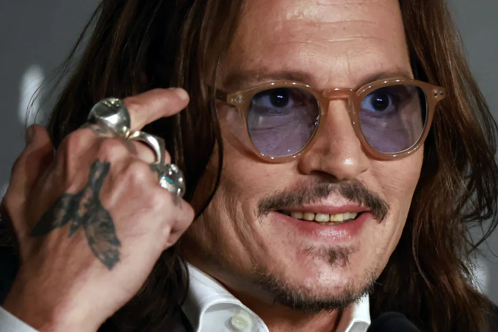 Johnny Depp responds to concerns about his weird smile.